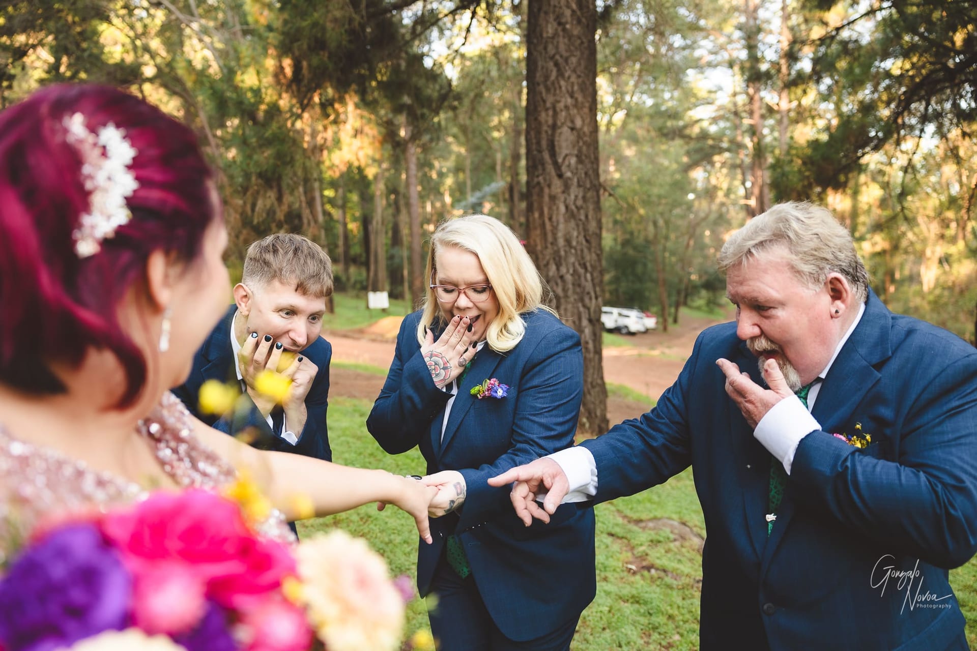 Bridal party fun! the grooms people admiring the wedding ring!