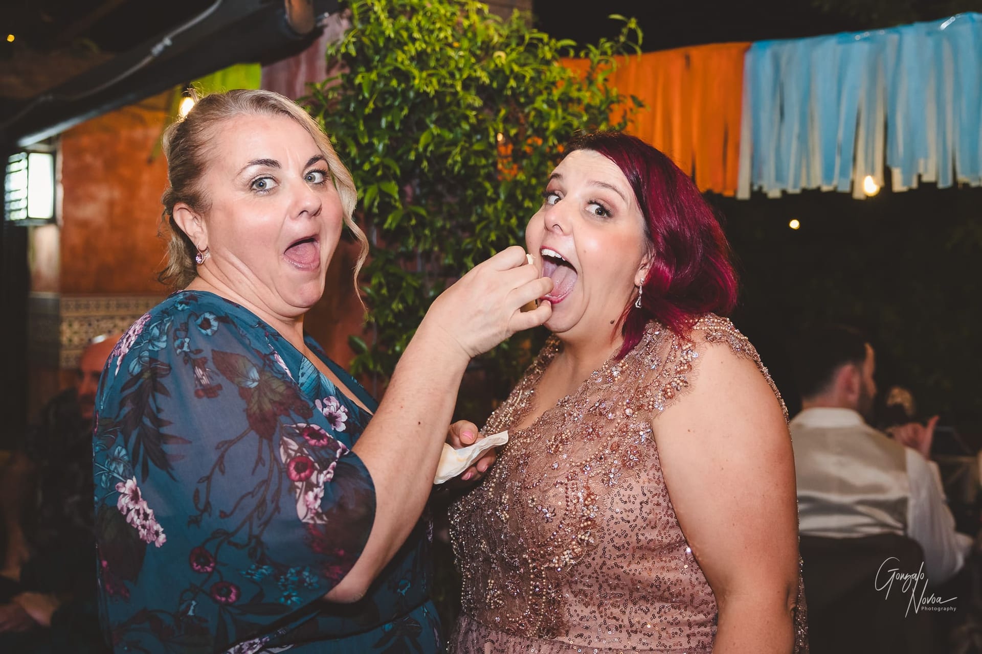 Bride getting hand-fed by one of her guests