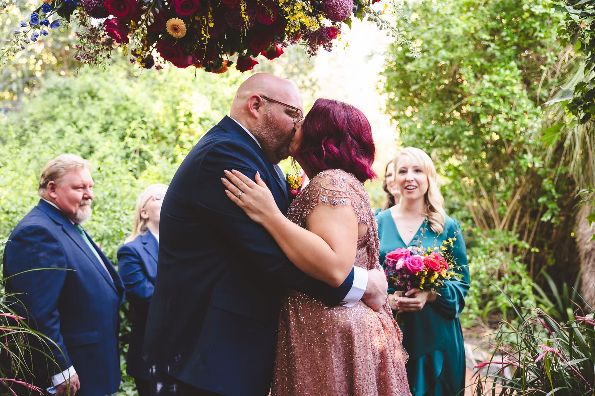 The first kiss! in front of the bridal party.