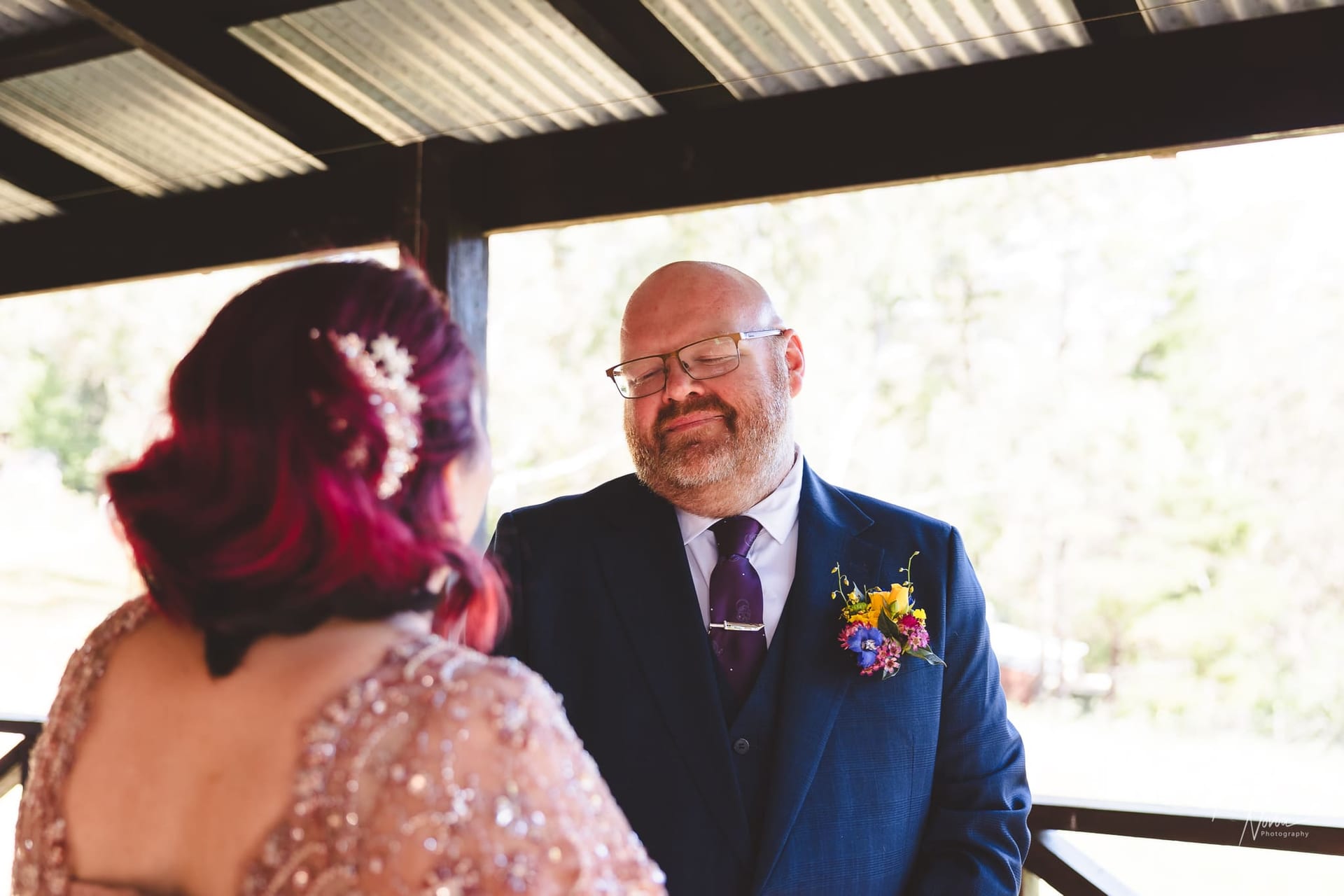 The first look! The groom gets his first look at his bride and a wholesome smile is seen on his face