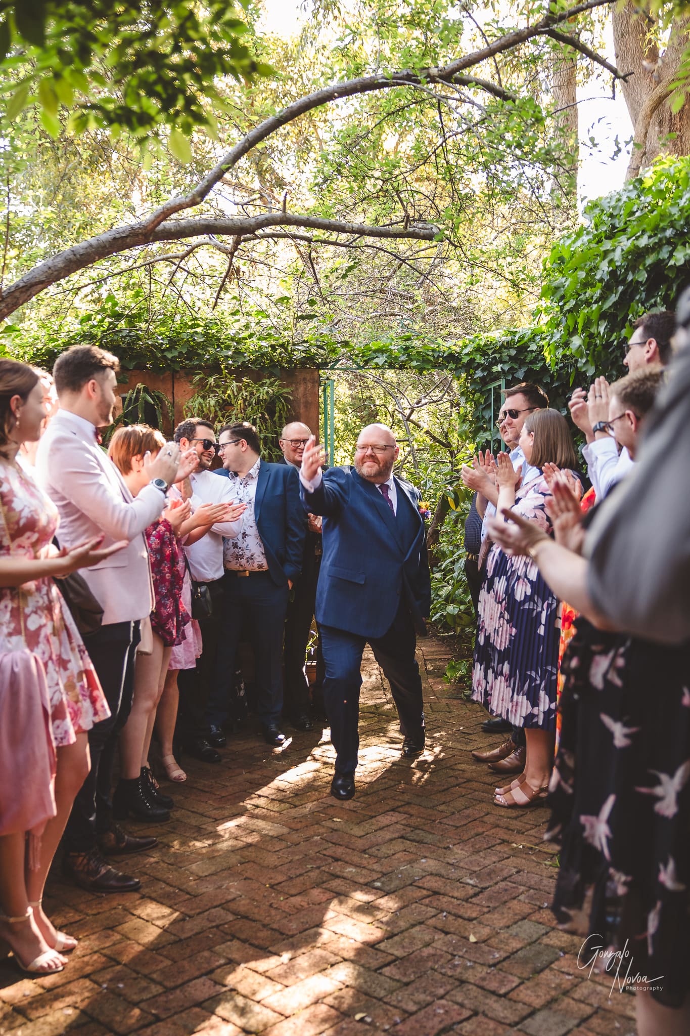 The groom's big entrance! Bradford strolls confidently walks through the bustling crowd of guests!