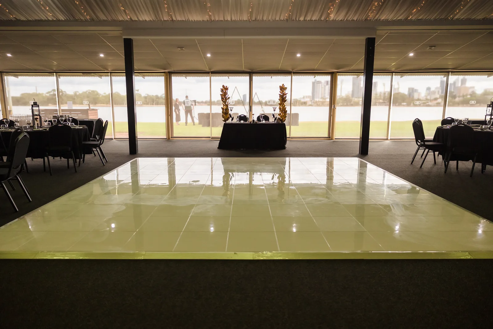 The reception dance floor with the Perth skyline through the windows at Burswood on Swan