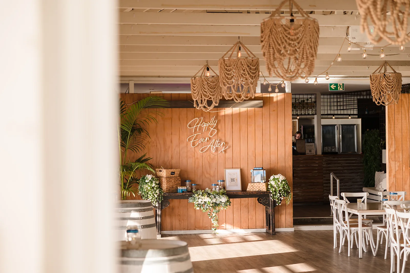Rattan pendant lights and timber interior at a COAST Port Beach wedding