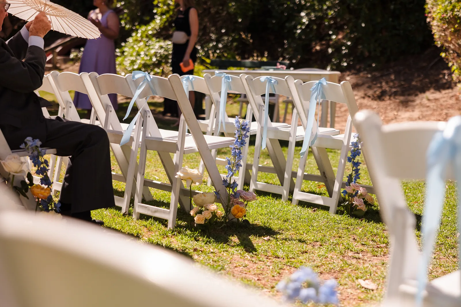White ceremony chairs set up in the garden at Cottesloe Civic Centre