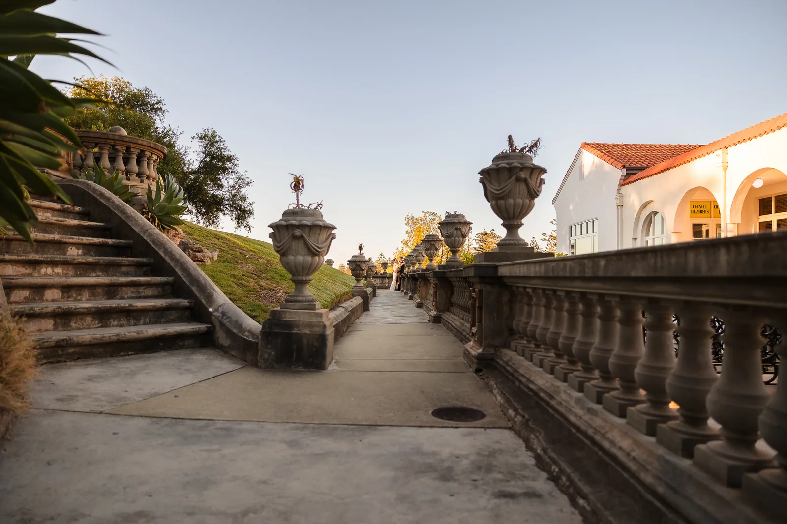 The loggia, ornate stone urns and golden garden path at Cottesloe Civic Centre